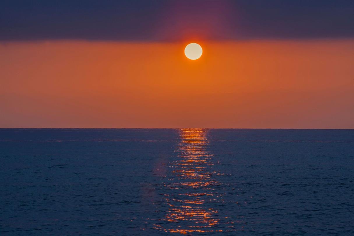 Sunset from the beach of Bagheera - naturist campsite by the sea in Corsica