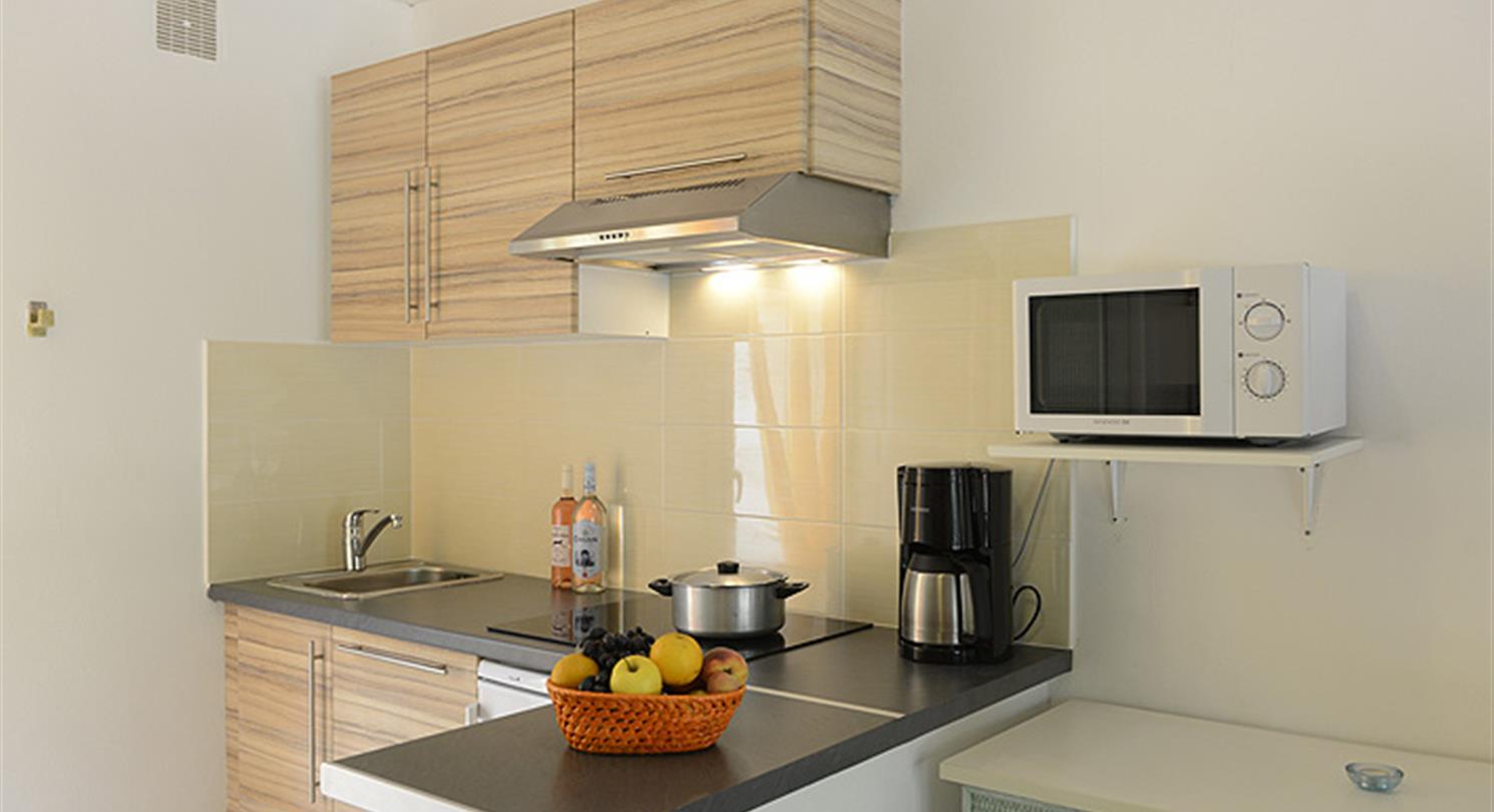 Kitchen of the studio, villa, in naturist residence and campsite in Corsica, near nudist beach
